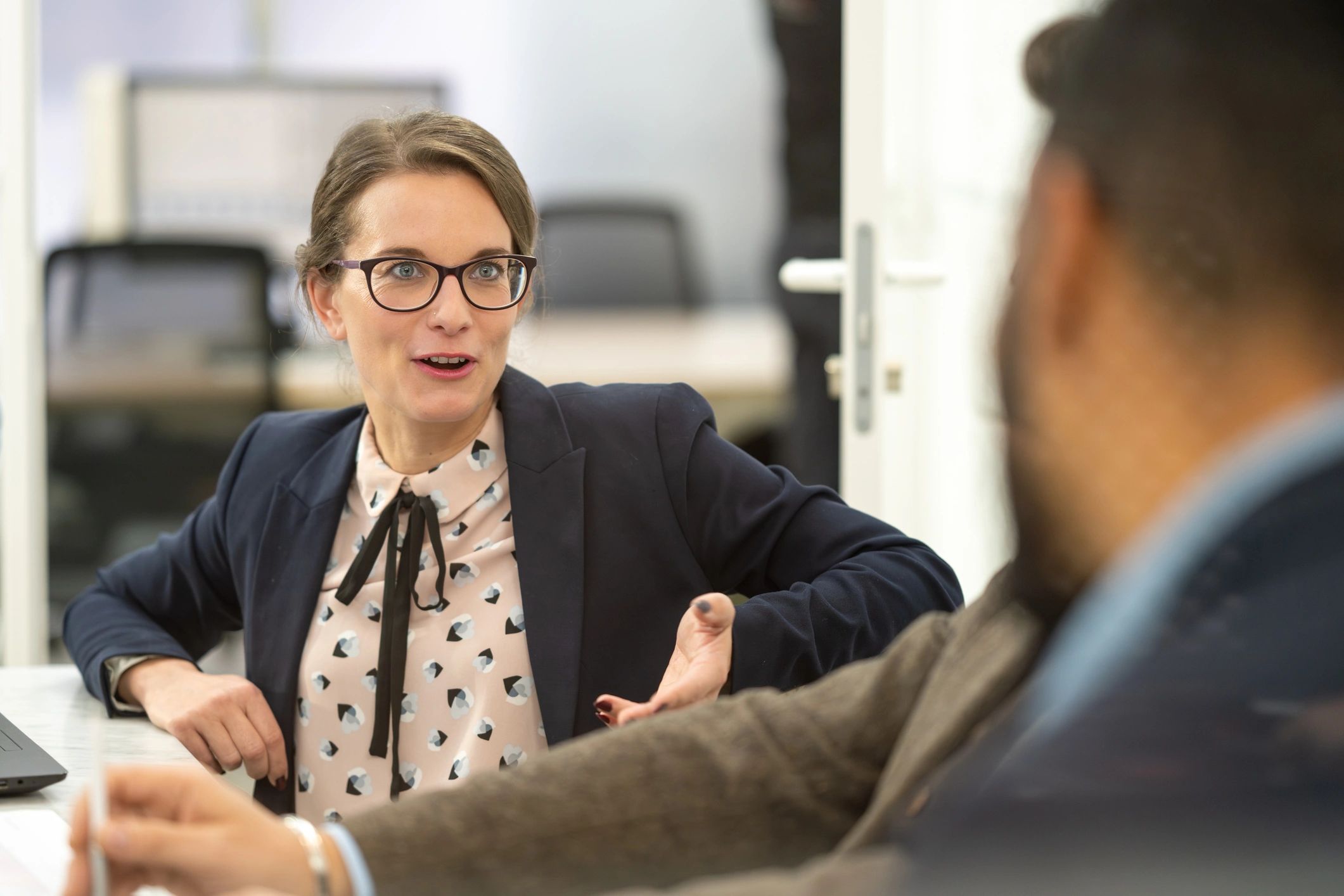 Two professionals in a collaborative coaching conversation